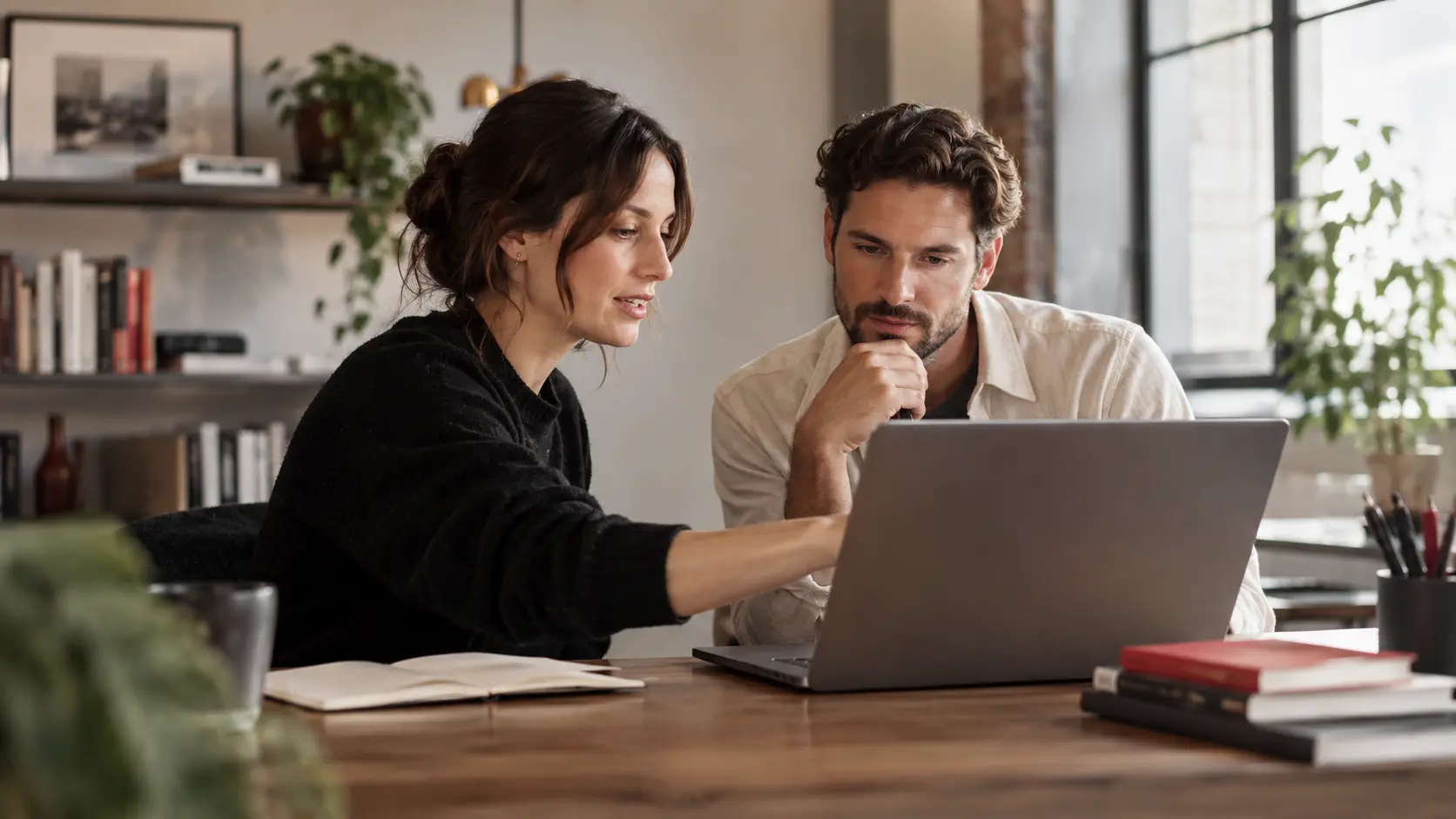 A designer and business employee testing a task-focused internal application on a laptop, collaborative practical prototype review.